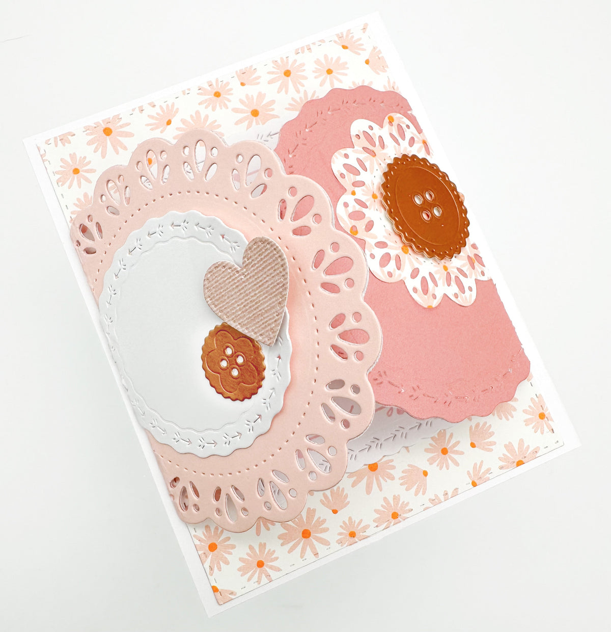 Peach floral handmade card with layered doily circles, a heart and paper buttons