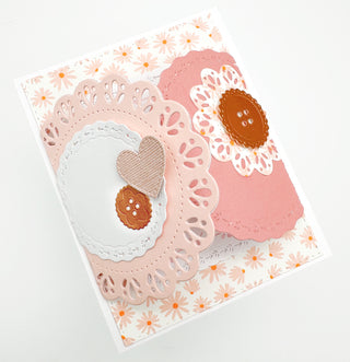 Peach floral handmade card with layered doily circles, a heart and paper buttons